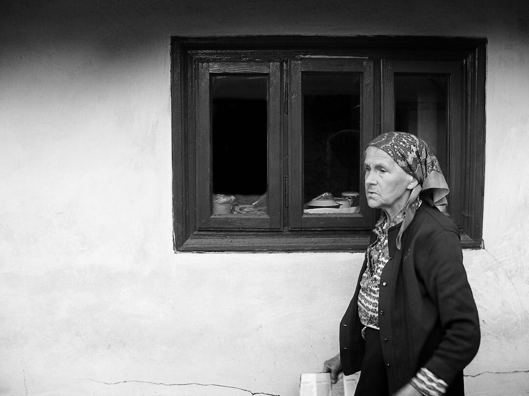 Elderly Danish woman knitting by a window