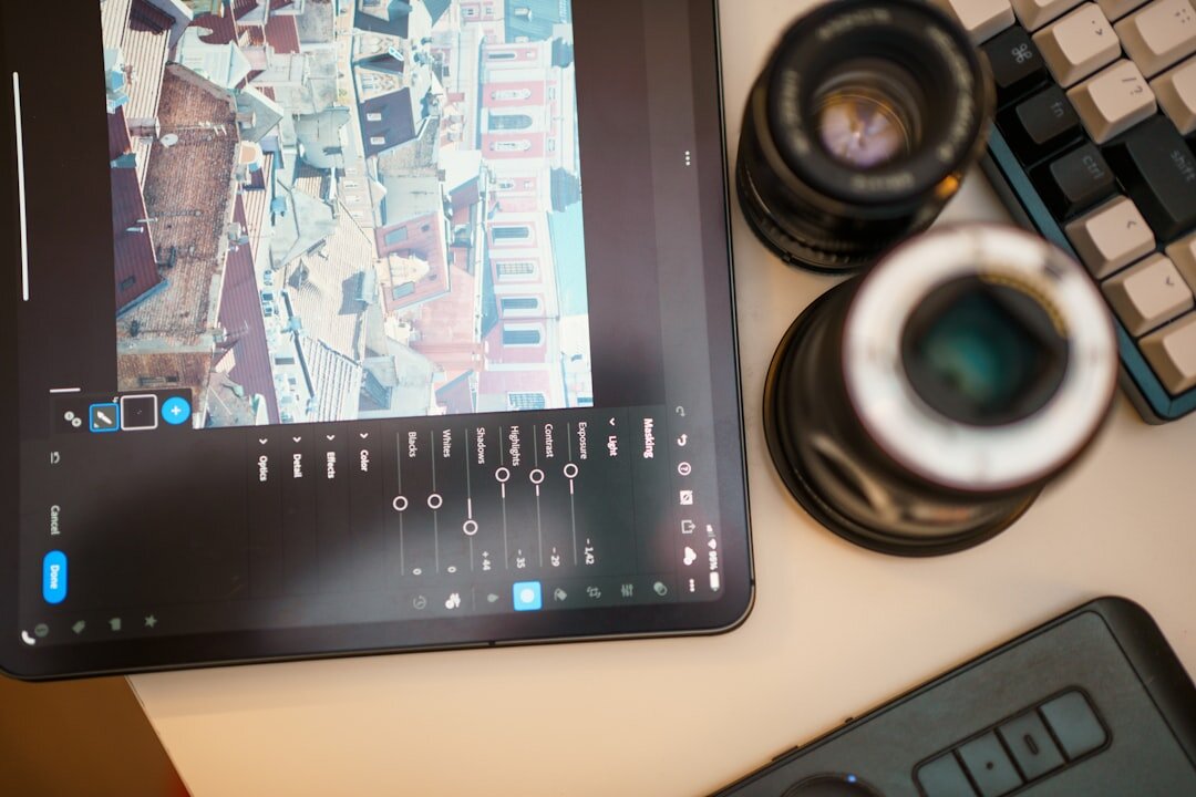 Photographer editing photos on a laptop in a studio